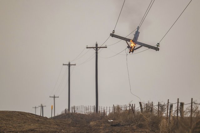 A telephone pole burns from the Smokehouse Creek Fire, Wednesday, February 28, 2024, in Canadian, Texas. (Photo by David Erickson/AP Photo)