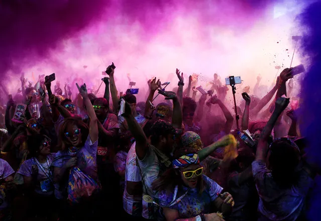 Colored powder is sprayed on runners as they celebrate during a “Color Fun Run” in Pasay city, Metro Manila, Philippines January 7, 2018. (Photo by Romeo Ranoco/Reuters)