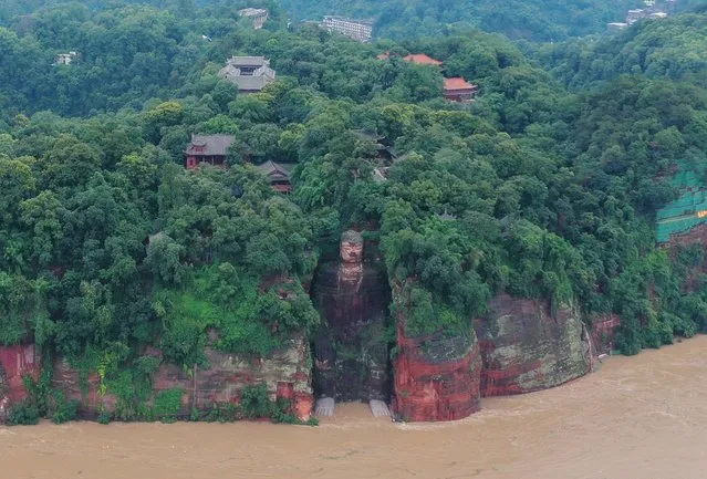 A view of the Leshan Giant Buddha as floodwater reaches the statue's feet following heavy rainfall in Leshan, Sichuan province, China, 18 August 2020. Authorities were forced to evacuate more than 100,000 people on 18 August 2020 after flooding on the upper reaches of the Yangtze river, and flood water reaches the feet of the Leshan Giant Buddha, 1,200-year-old world heritage site. (Photo by Li Xinfeng/EPA/EFE)