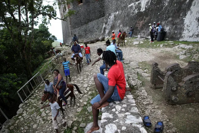 American tourists Janet Moore and Leonard Moore ride horses on their way down from the Citadel Laferriere in Milot, Haiti, November 19, 2017. The Citadel Laferriere is one of the main touristic attractions in Haiti and it is considered a World Heritage Site according to United Nations Educational, Scientific and Cultural Organization (UNESCO). (Photo by Andres Martinez Casares/Reuters)