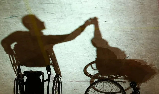 Shadow cast by a pair dancing on wheelchairs during IPC Wheelchair Dance Sport European Championships in  Lomianki near Warsaw, November 9, 2014. (Photo by Kacper Pempel/Reuters)
