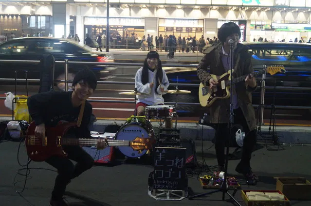 A teen rock band performs outside Shinjuku Station in Tokyo on November 10, 2017. (Photo by Michael Walsh/Yahoo News)