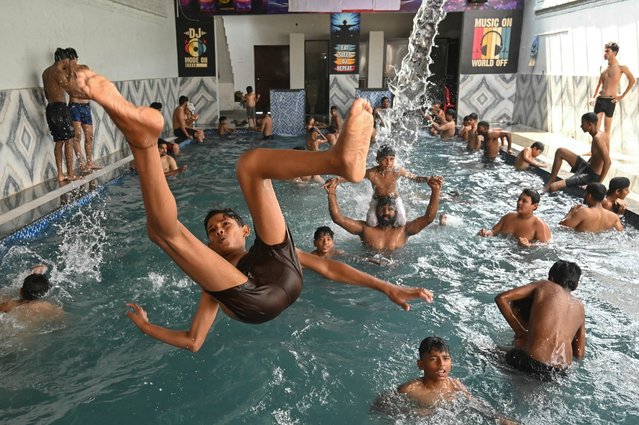 People cool off by diving into a swimming pool on a hot summer day in Amritsar, India, on June 8, 2025. (Photo by Narinder Nanu/AFP Photo)
