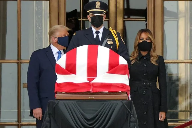 U.S. President Donald Trump reacts to people on the sidewalk booing him while he and First Lady Melania Trump pay their respects to late Associate Justice Ruth Bader Ginsburg as her casket lies in repose at the top of the steps of the U.S. Supreme Court building in Washington, U.S., September 24, 2020. (Photo by Jonathan Ernst/Reuters)
