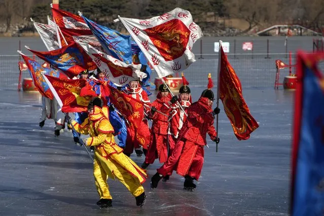 Chinese artists dressed in traditional costumes perform an ice frolic on a frozen lake at the Yuanmingyuan Garden during the second day of the Lunar New Year celebrations in Beijing, Monday, January 23, 2023. The Lunar New Year is the most important annual holiday in China. Each year is named after one of the 12 signs of the Chinese zodiac in a repeating cycle, with this year being the Year of the Rabbit. For the past three years, celebrations were muted in the shadow of the pandemic. (Photo by Andy Wong/AP Photo)