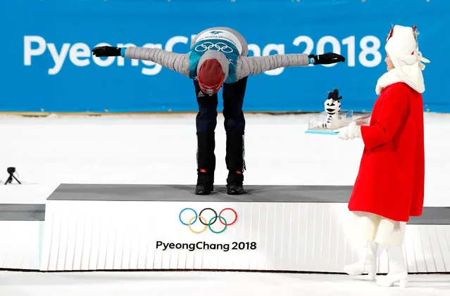 Gold medalist Anastasiya Kuzmina of Slovakia celebrates alongside silver medalist Darya Domracheva of Belarus and bronze medalist Tiril Eckhoff of Norway during the victory ceremony after the Women's 12.5km Mass Start Biathlon on day eight of the PyeongChang 2018 Winter Olympic Games at Alpensia Biathlon Centre on February 17, 2018 in Pyeongchang-gun, South Korea. (Photo by Jorge Silva/Reuters)