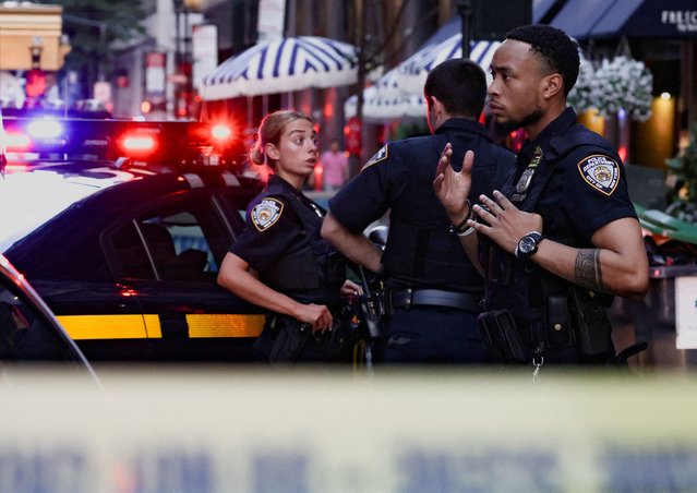 Police officers gather during a reported active shooter situation in the Manhattan borough of New York City on July 28, 2025. (Photo by Jeenah Moon/Reuters)