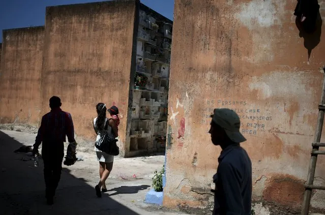 People walk at the General Cemetery in Guatemala City October 31, 2015. (Photo by Jorge Dan Lopez/Reuters)