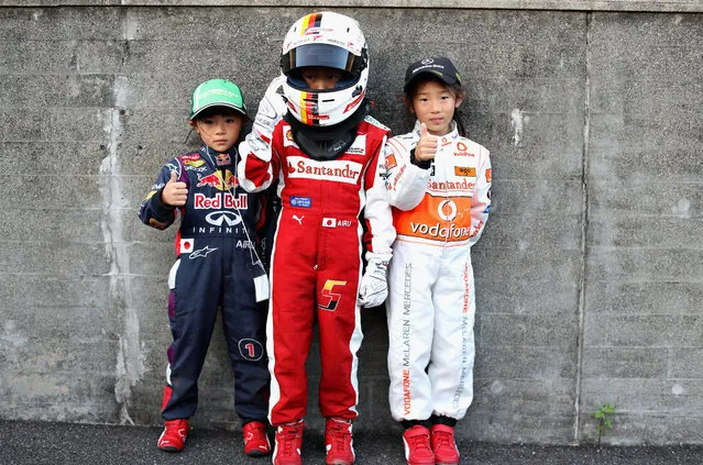 Young fans wearing Red Bull Racing, Ferrari and McLaren outfits during previews ahead of the Formula One Grand Prix of Japan at Suzuka Circuit on October 6, 2016 in Suzuka. (Photo by Mark Thompson/Getty Images)