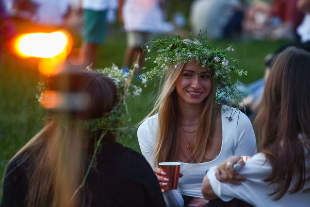Participants celebrate the summer solstice during the “Kupala Night” by the Krakus Mound in Krakow, Poland on June 20th, 2024. The Kupala Night is Old Slavic holiday falling on the shortest night of the year. During that night rituals were performed such as gathering and making crowns from herbs and wild flowers by girls and young women, sending garlands on water; lighting fires, dancing, singing, and jumping over fire. (Photo by Beata Zawrzel/ZUMA Press Wire/Rex Features/Shutterstock)
