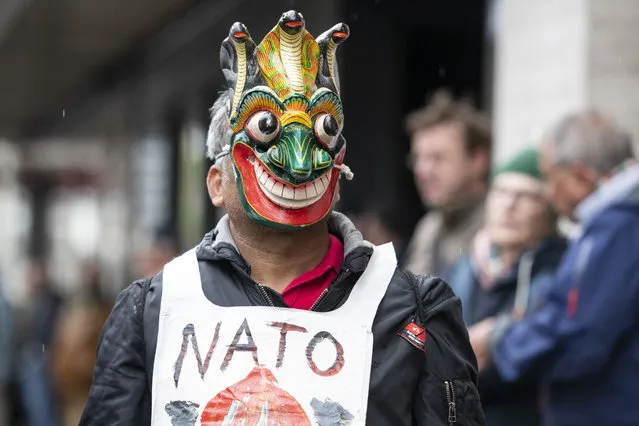 A disguised protestor attends a rally to mark the International Labor Day, in Zurich, Switzerland, on May 1, 2018. (Photo by Patrick Huerlimann/Keystone via AP Photo)