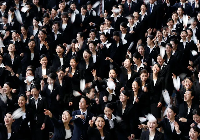 Newly hired employees of Japan Airlines (JAL) group fly paper planes during the company group's initiation ceremony at a hangar of Haneda airport in Tokyo, Japan, April 2, 2018. (Photo by Issei Kato/Reuters)