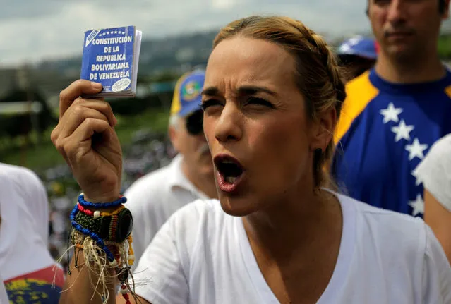Lilian Tintori  wife of jailed Venezuelan opposition leader Leopoldo Lopez, holding a copy of the Venezuelan constitution , takes part in a rally against Venezuela's President Nicolas Maduro's government in Caracas, Venezuela, October 26, 2016. (Photo by Marco Bello/Reuters)