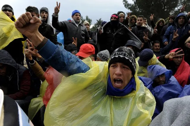 Migrants shout slogans during a demonstration as they wait to cross the Greek-Macedonian borders near the village of Idomeni, Greece, November 22, 2015. (Photo by Alexandros Avramidis/Reuters)