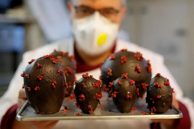 French chocolate maker Jean-Francois Pre displays Easter eggs shaped as coronavirus in his pastry shop ahead of Easter celebrations in Landivisiau, as the spread of the coronavirus disease (COVID-19) continues in France, April 8, 2020. (Photo by Stephane Mahe/Reuters)