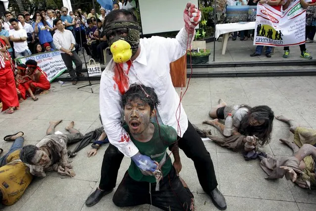 Filipino environmental activists perform during a "Climate Solidarity Prayer" march ahead of the 2015 Paris Climate Change Conference, known as the COP21 summit, in Manila November 29, 2015. (Photo by Czar Dancel/Reuters)