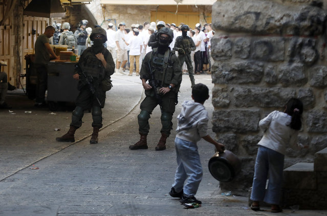 Members of Israeli forces secure the streets for Israeli settlers in the West Bank city of Hebron, November 1, 2025. (Photo by Xinhua News Agency/Rex Features/Shutterstock)