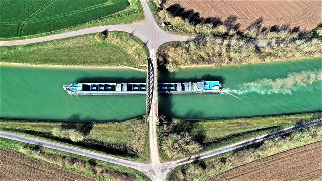 A river barge sails on the Canal du Nord in Graincourt-les-Havrincourt, France on April 3, 2023. (Photo by Pascal Rossignol/Reuters)