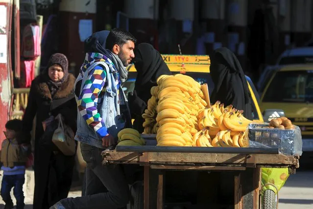 A man displays bananas for sale in Idlib, Syria December 6, 2015. (Photo by Ammar Abdullah/Reuters)