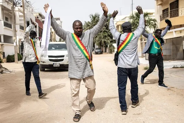 Elected opposition officials hold their hands up after teargas was fired while they were trying to meet with opposition leader, Ousmane Sonko (not pictured) who is under house arrest in Dakar on May 31, 2023, one day prior to the final verdict in his rape trail, set for June 1, 2023. Sonko, 48-year-old leader of the PASTEF-Patriots party, is a fiery critic of head of state Macky Sall and wields a big following among young people. He came third in the 2019 presidential elections and has already declared he will contest next year's ballot. He faces the expected verdict on June 1 of a rape trial whose details have left the conservative West African state riveted. (Photo by John Wessels/AFP Photo)