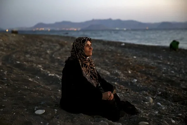 Amoun, 70, a blind Palestinian refugee who lived in the town of Aleppo in Syria, rests on a beach moments after arriving by dinghy on the Greek island of Kos, crossing a part of the Aegean Sea from Turkey to Greece, August 12, 2015. Reuters photographer Yannis Behrakis: “I was on a beach in Kos waiting for rafts containing refugees and migrants to arrive. When this raft arrived I took some pictures and gave the people directions to the police station to register, reassuring them, as my colleagues and I did again and again, that nobody was going to harm them. (Photo by Yannis Behrakis/Reuters)