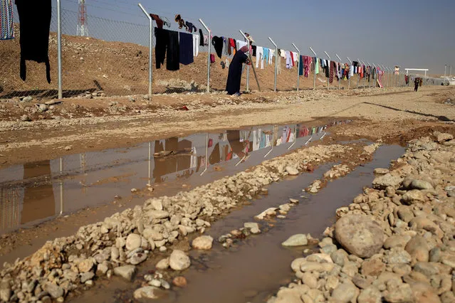 A newly displaced woman hangs her washing in Khazer refugee camp, Iraq November 11, 2016. (Photo by Zohra Bensemra/Reuters)