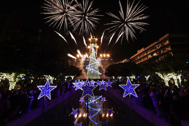 Hundreds of people watch the inauguration of the lighting of the traditional Christmas tree in the center of Porto, which included a video mapping show on the facade of the city hall building and also a pyrotechnic show, November 30, 2024. (Photo by Estela Silva/LUSA)