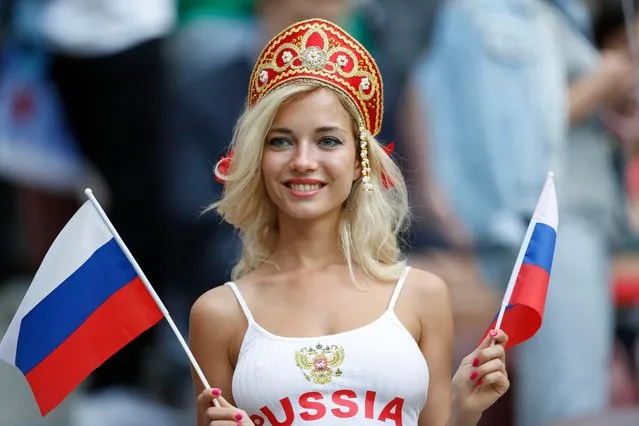A Russian fan poses for the cameras as she gets ready to cheer on their side as they pose a photograph before the start of the group A match between Russia and Saudi Arabia which opens the 2018 soccer World Cup at the Luzhniki stadium in Moscow, Russia, Thursday, June 14, 2018. Russia’s hottest World Cup fan revealed to be a p*rn star named Natalya Nemchinova after randy supporters track down her X-rated movies. (Photo by Antonio Calanni/AP Photo)