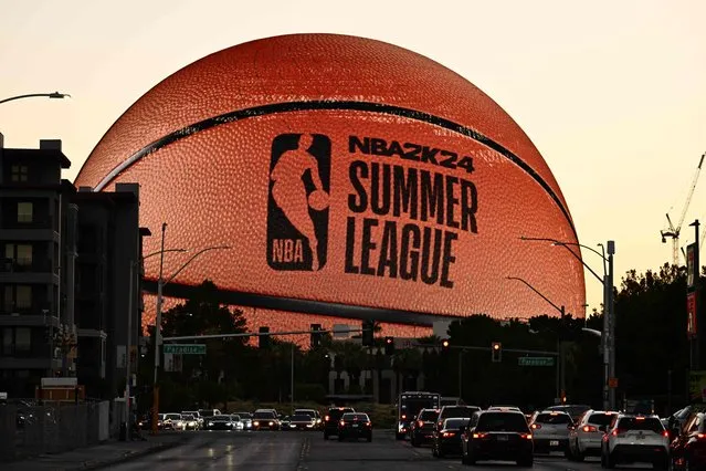 The MSG (Madison Square Garden) Sphere, new music entertainment arena, is lit up as a basketball to celebrate the 2023 NBA Summer League in Las Vegas, Nevada, on July 9, 2023. (Photo by Patrick T. Fallon/AFP Photo)