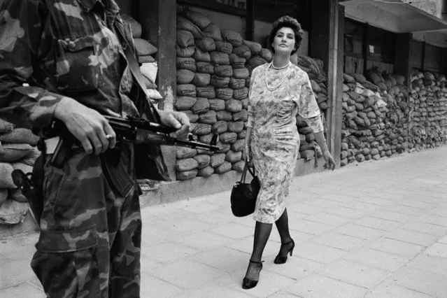 1994 Visa d'or Feature: Tom Stoddart. “It was 1993 and the Siege of Sarajevo was at its bloodiest. I was working on a photo essay documenting the daily lives of women in that war torn city. There I was shooting one day, sheltering by sand bags, when suddenly, a beautiful woman appeared in the deserted street. (Photo by Tom Stoddart)