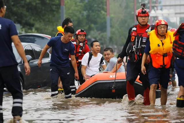 Rescue workers evacuate flood-affected residents using a boat after remnants of Typhoon Doksuri brought rains and floods in Beijing, China on August 2, 2023. (Photo by Tingshu Wang/Reuters)