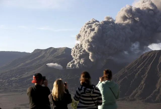 Tourists watch as Mount Bromo erupts near Ngadisari, Probolinggo, East Java, Indonesia January 6, 2016. (Photo by Darren Whiteside/Reuters)