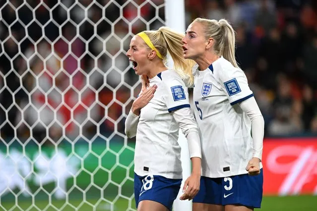 Chloe Kelly of England (left) celebrates after kicking the winning penalty goal with teammate Alex Greenwood of England after the FIFA Women's World Cup 2023 Round of 16 soccer match between England and Nigeria at Brisbane Rectangular Stadium in Brisbane, Australia, 07 August 2023. (Photo by Darren England/EPA)