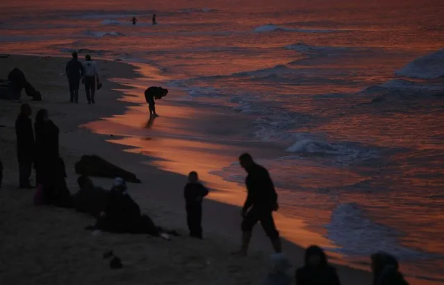 Palestinians walk along the beach of Gaza City after sunset, February 6, 2015. (Photo by Mohammed Salem/Reuters)