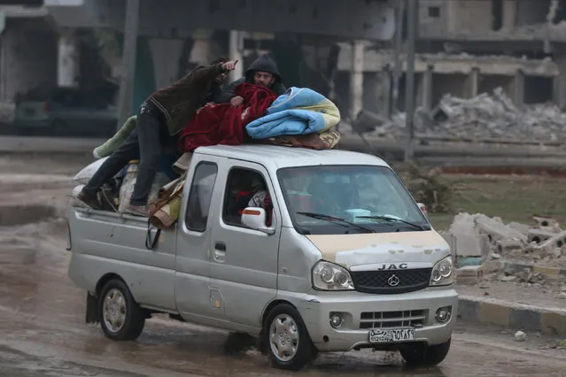 People ride on a pick-up truck as they flee deeper into the remaining rebel-held areas of Aleppo, Syria December 7, 2016. (Photo by Abdalrhman Ismail/Reuters)