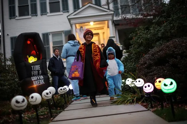 Children in Halloween costumes go trick or treating in the New York City suburb of Upper Nyack, New York, U.S., October 31, 2023. (Photo by Mike Segar/Reuters)
