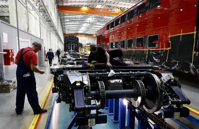 Employees work on an electric train assembly line at the “Stadler Minsk” plant in Fanipol, Belarus February 10, 2016. (Photo by Vasily Fedosenko/Reuters)
