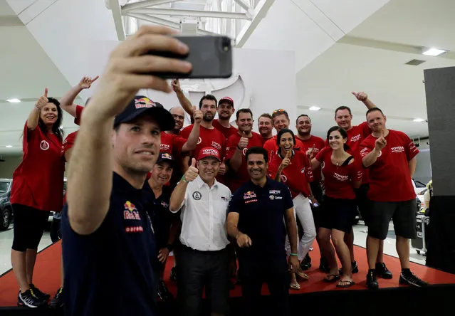 Co-pilot Matthieu Baumel takes a selfie of driver Nasser Al-Attiyah (front  R) after the presentation of the Toyota team at the bivouac of the Dakar Rally 2017  in Luque, Paraguay, December 30, 2016. (Photo by Jorge Adorno/Reuters)