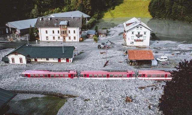 A train is stuck after flooding caused a landslide after a thunderstorm flooded the Krimmler Ache in Wald im Pinzgau, Austria on Tuesday, August 17, 2021. (Photo by JFK/Expa/AFP Photo)