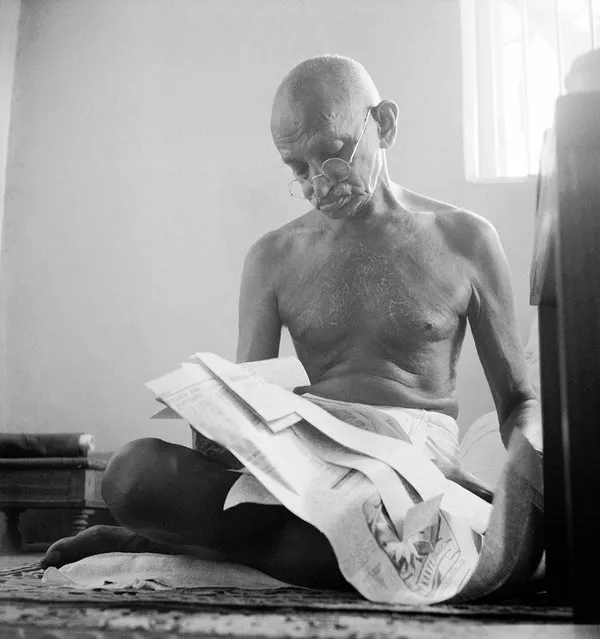Indian leader Mohandas Gandhi reading as he sits cross-legged on floor, at home on January 01, 1946. (Photo by Margaret Bourke-White/The LIFE Picture Collection/Getty Images)