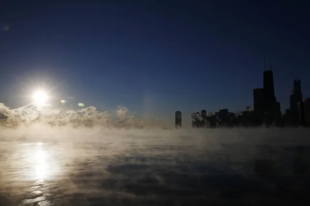 The Chicago skyline is seen as the arctic sea smoke rises off Lake Michigan in Chicago, Illinois, January 6, 2014.  A blast of Arctic air gripped the mid-section of the United States on Monday, bringing the coldest temperatures in two decades. Meteorologists said temperatures were dangerously cold and life-threatening in some places, with 0 degrees Fahrenheit (minus 18 Celsius) recorded in Chicago, St. Louis and Indianapolis. (Photo by Jim Young/Reuters)