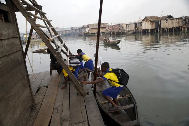 Students who attend a floating school arrive by canoe to school in the Makoko fishing community on the Lagos Lagoon, Nigeria February 29, 2016. (Photo by Akintunde Akinleye/Reuters)