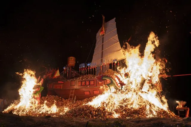 Wangkang ship is set aflame during the night culminating ceremony so that the collected spirits can symbolically sail into another realm during Wangkang or “royal ship” festival at Yong Chuan Tian Temple in Malacca, Malaysia, Thursday, January 11, 2024. (Photo by Vincent Thian/AP Photo)