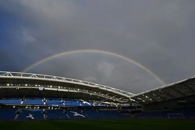 A rainbow is pictured behind the stands ahead of the UEFA Europa League Group B football match between Brighton and Hove Albion and Ajax at the American Express Community Stadium in Brighton, southern England on October 26, 2023. (Photo by Glyn Kirk/AFP Photo)