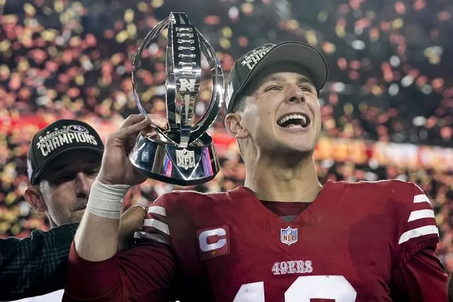 San Francisco 49ers quarterback Brock Purdy celebrates with the trophy after their win against the Detroit Lions in the NFC Championship NFL football game in Santa Clara, Calif., Sunday, January 28, 2024. (Photo by Godofredo A. Vasquez/AP Photo)