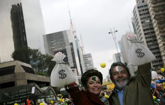 Cardboard cutouts depicting Brazil's former President Luiz Inacio Lula da Silva (R) and Brazil's President Dilma Rousseff are seen during a protest against Rousseff, part of nationwide protests calling for her impeachment, in Sao Paulo, Brazil, March 13, 2016. (Photo by Nacho Doce/Reuters)