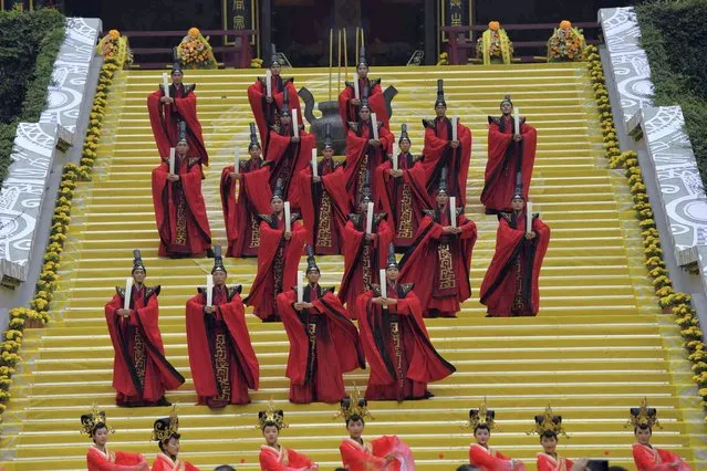 Dancers perform a ritual dance during a ceremony honoring the mythological ancestor Huangdi, also known as the Yellow Emperor, in Jinyun county in eastern China's Zhejiang province Thursday, October 14, 2021. Huangdi was believed to have ruled China around 5000 years ago and rituals for honoring and worshipping Huangdi dates back some 1600 years, according the local Zhejiang media. (Photo by Chinatopix via AP Photo)