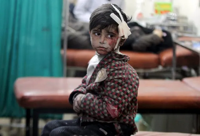 An injured boy waits inside a field hospital after what activists said were airstrikes and shelling by forces loyal to Syria's President Bashar al-Assad in the Douma neighborhood of Damascus April 22, 2015. (Photo by Mohammed Badra/Reuters)