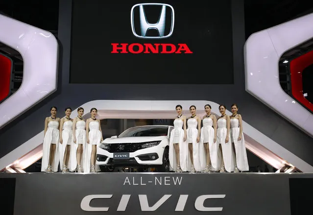 Models pose beside a Honda All-New Civic during a media presentation at the 37th Bangkok International Motor Show in Bangkok, Thailand, March 22, 2016. (Photo by Chaiwat Subprasom/Reuters)