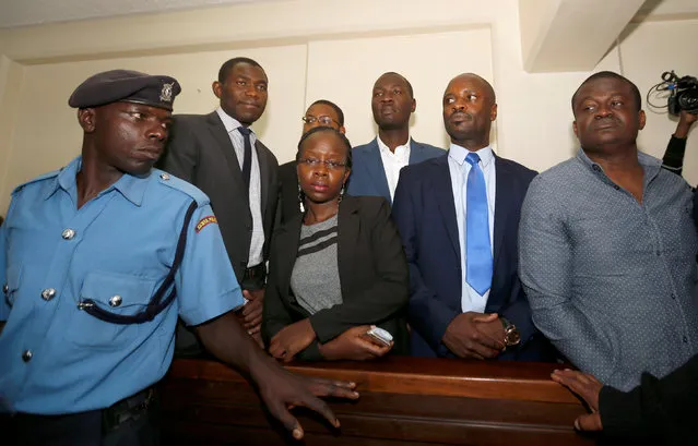 A policeman guards officials of the Kenya Medical Practitioners, Pharmacists and Dentist Union (KMPDU), standing in the dock during their case to demand fulfilment of a 2013 agreement between their union and the government that would raise their pay and improve working conditions at the employment and labour relations courts in Nairobi, Kenya, February 13, 2017. (Photo by Thomas Mukoya/Reuters)